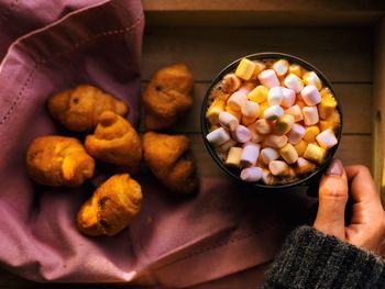 High angle view of hand holding cookies