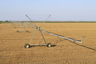 Bicycle on field against clear sky