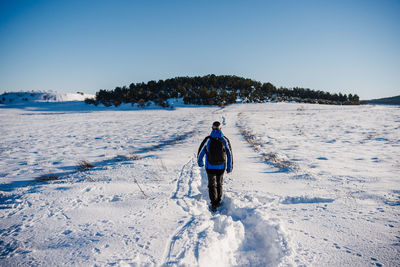 Man hiking in snowy mountain in a sunny day. nature. winter season