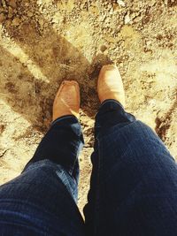 Low section of woman standing on ground