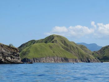 Scenic view of sea and mountains against sky