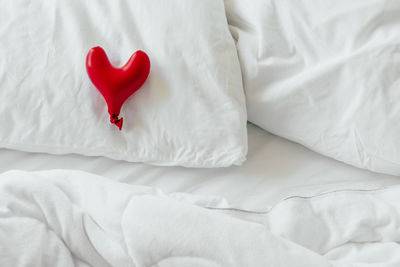 High angle view of heart shape on bed