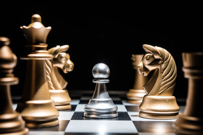 Close-up of chess pieces against black background