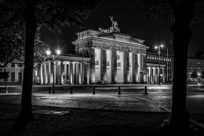 Brandenburg gate and illuminated street lights at night