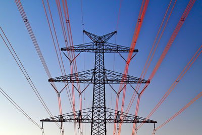 Low angle view of electricity pylon against sky