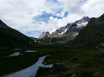 Scenic view of mountains against cloudy sky