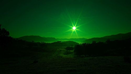 Scenic view of silhouette landscape against sky at night