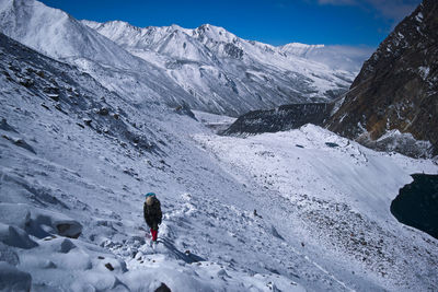 Tourists on snow covered mountain