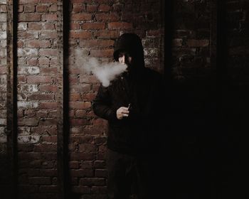Woman standing against wall