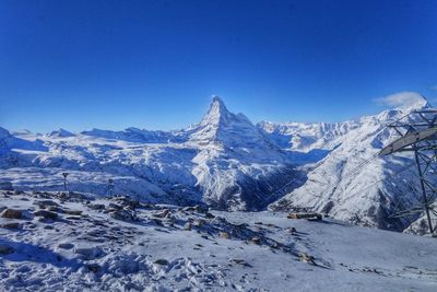 View of snowcapped mountain against blue sky