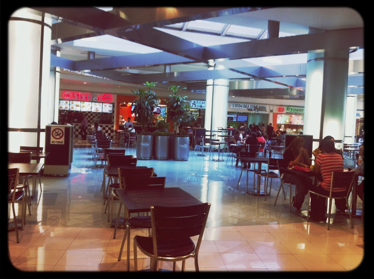 chair, indoors, table, restaurant, empty, absence, transfer print, seat, auto post production filter, built structure, sitting, sidewalk cafe, arrangement, cafe, incidental people, bench, architecture, relaxation, person, place setting