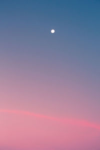 Low angle view of moon at sunset
