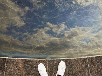 Low section of man standing in water