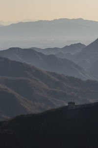 Scenic view of silhouette mountains against sky during sunset