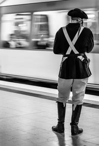 Rear view of man wearing costume at subway station