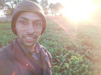 Portrait of smiling young man against plants