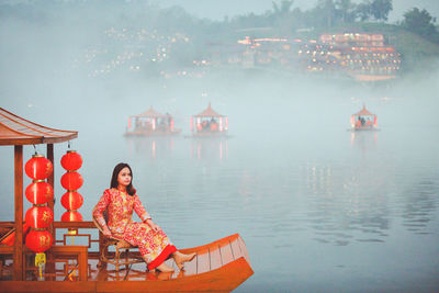 Asian woman wearing cheongsam traditional red dress on chinese new year travel.