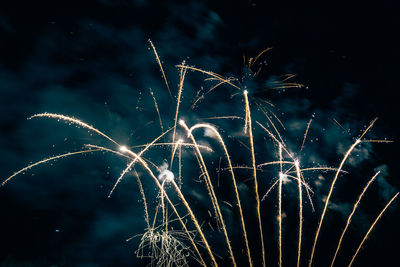 Low angle view of firework display at night