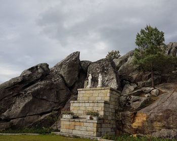 Low angle view of rock formation against sky