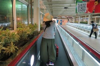 Rear view of people walking in train