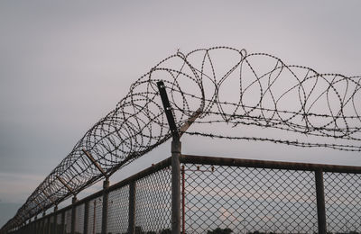 Prison security fence. barbed wire security fence. razor wire jail fence. barrier border. boundary.