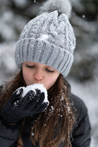 Close-up of girl eating snow