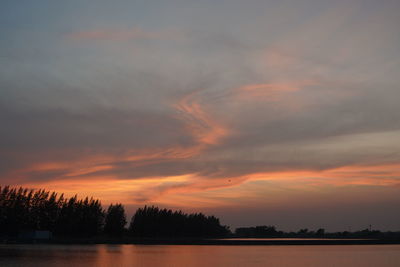 Scenic view of lake against romantic sky at sunset