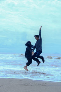 Full length of man enjoying on beach