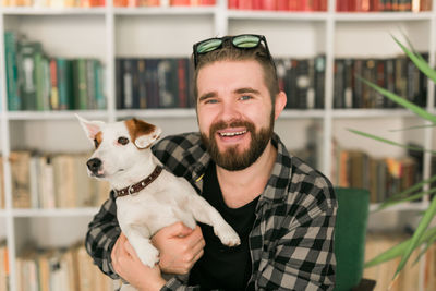 Portrait of a smiling young man with dog