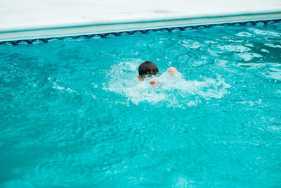 High angle view of boy swimming in pool