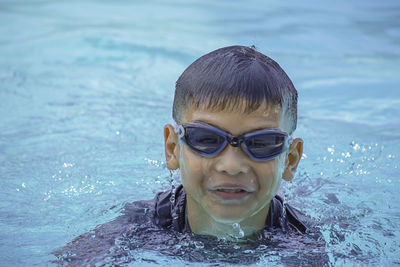 Portrait of boy swimming in pool