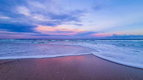 Scenic view of beach against sky during sunset