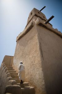 Low angle view of statue against built structure