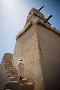 Low angle view of statue against built structure
