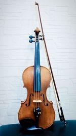 Violin and bow against wall