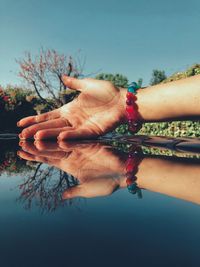 Cropped hand of woman on glass table