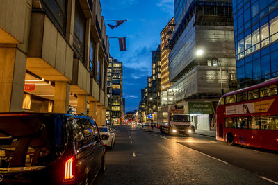 Cars on road amidst buildings in city