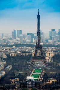 Eiffel tower amidst buildings in city