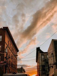 Low angle view of buildings against sky at sunset