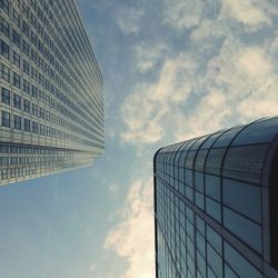 Low angle view of modern building against cloudy sky