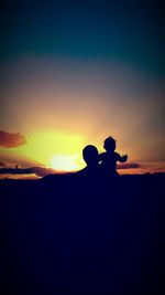 Silhouette men against sky during sunset