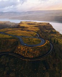 High angle view of lollipop road by cliff against sky