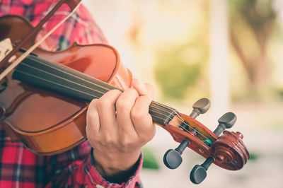 Close-up of man playing guitar