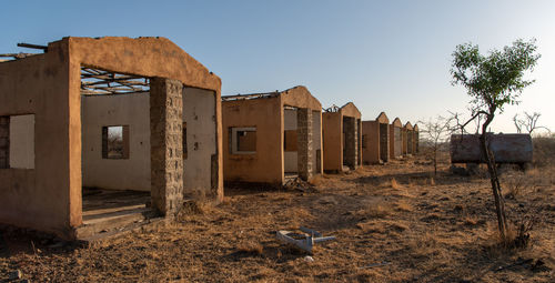 View of abandoned buildings against clear sky