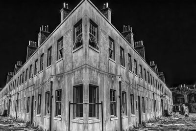 Abandoned building against sky at night