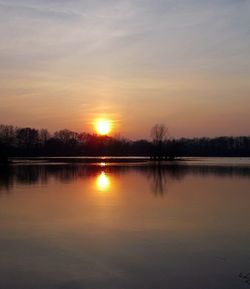 Scenic view of lake against sky during sunset