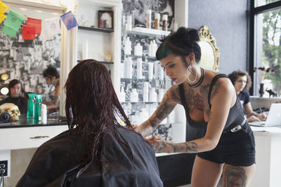 A hair dresser styling a customer's hair.