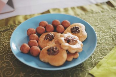 High angle view of cookies by marzipan in plate on table