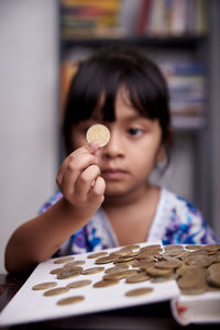 Portrait of boy holding ice cream on table