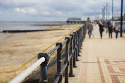 Very shallow focus or depth of field with out of focus people walking on the prom at cleethorpes